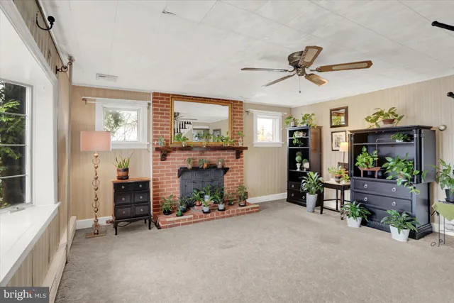 a living room with furniture and a fireplace