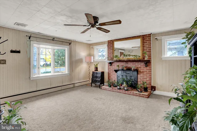 a view of an empty room with a fireplace and a window
