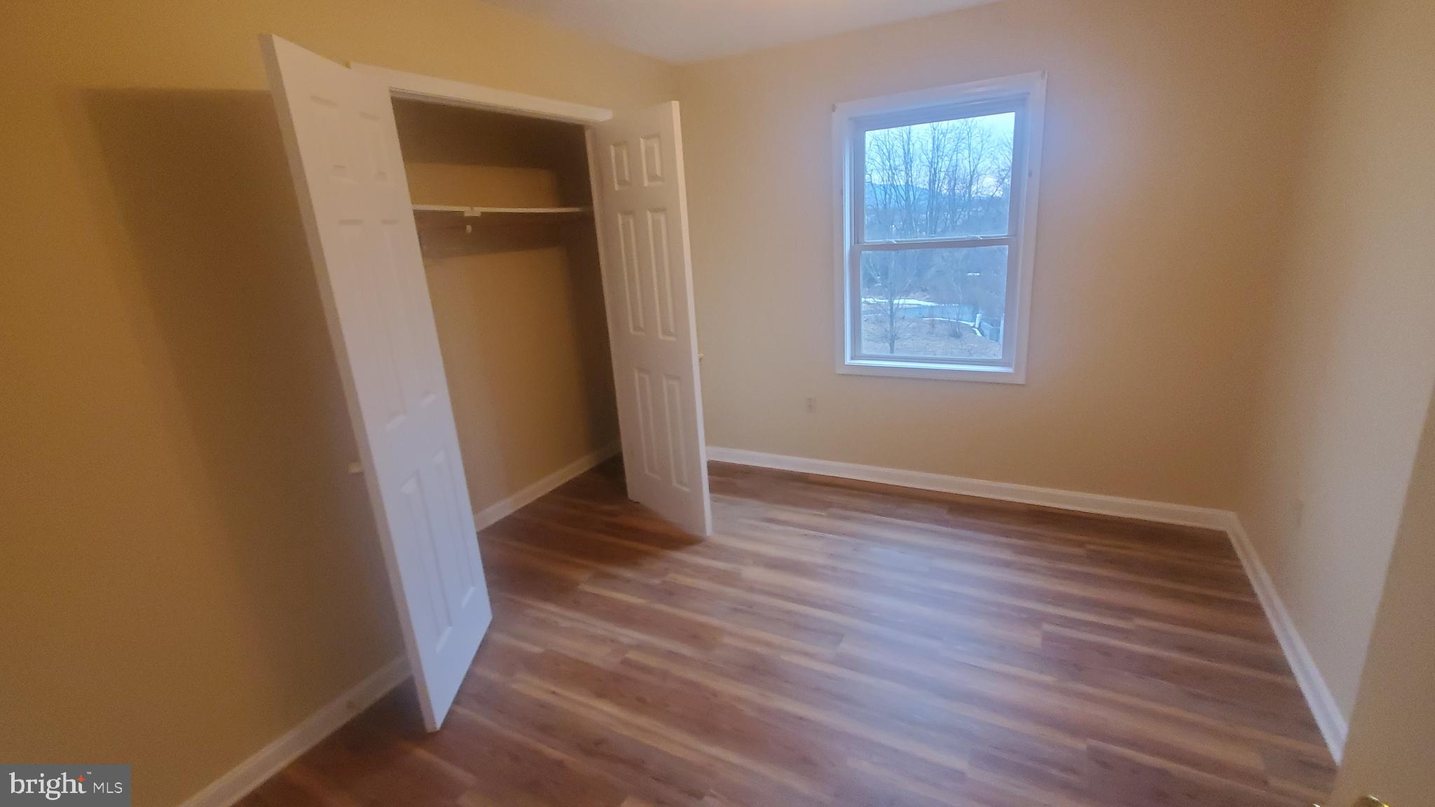 1292 South Ox Road Woodstock, VA 22664 - Photo 20 of 24 an empty room with wooden floor and windows