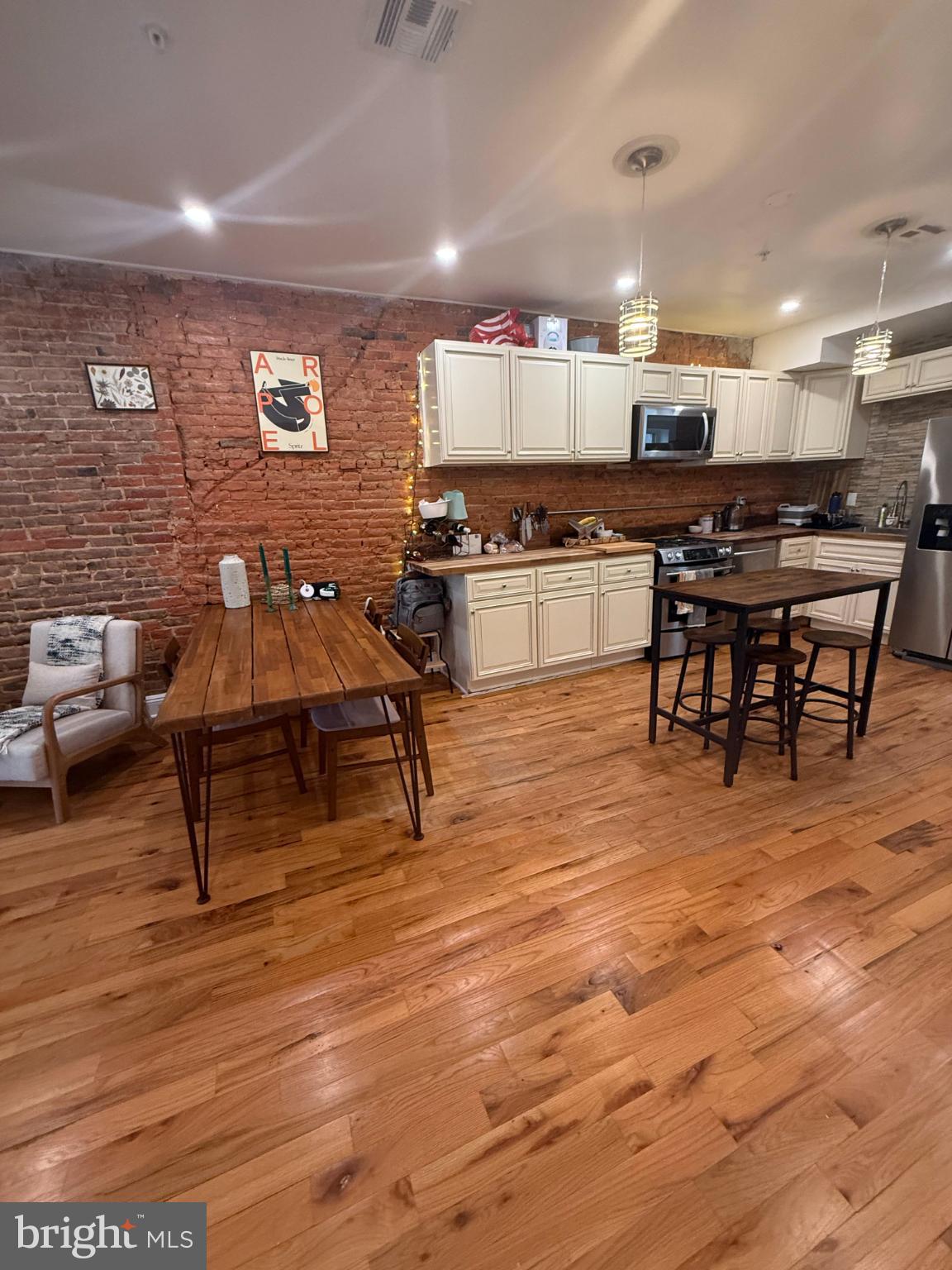 2005 North Mascher Street, Unit B Philadelphia, PA 19122 - Photo 8 of 31 a living room with stainless steel appliances kitchen island granite countertop a stove a sink a refrigerator and white cabinets