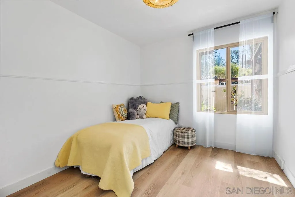 8722 Wahl Street Santee, CA 92071 - Photo 15 of 35 a bedroom with a bed and wooden floor