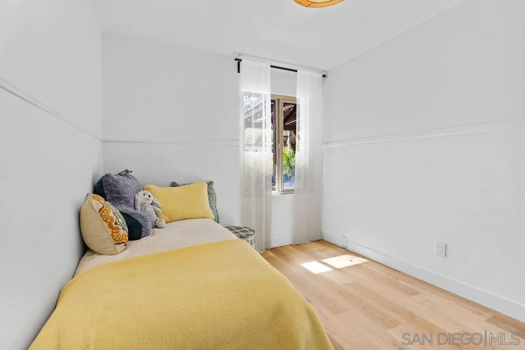 8722 Wahl Street Santee, CA 92071 - Photo 16 of 35 a bedroom with a bed and a potted plant