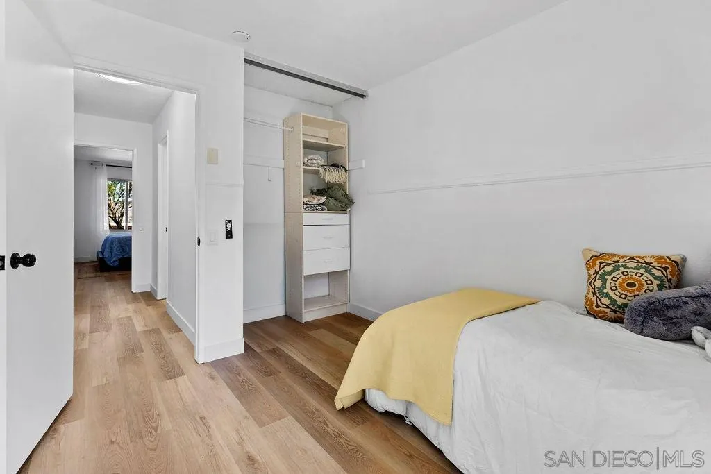 8722 Wahl Street Santee, CA 92071 - Photo 17 of 35 a bedroom with a bed and a wooden floor