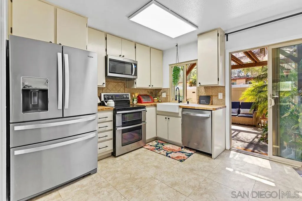 8722 Wahl Street Santee, CA 92071 - Photo 2 of 35 a kitchen with stainless steel appliances a refrigerator stove and sink