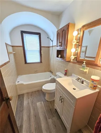 a bathroom with a toilet sink and mirror
