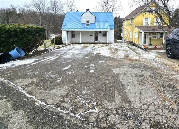 a front view of a building with a yard