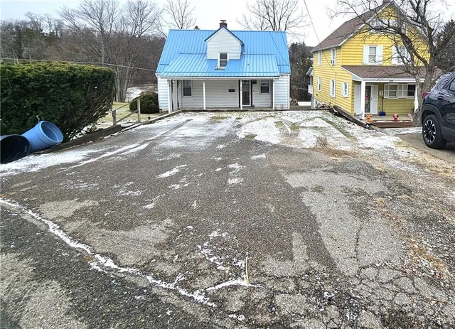 a front view of a building with a yard