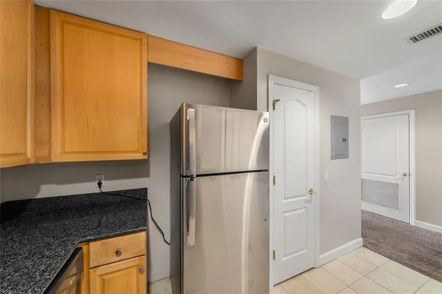 a kitchen with granite countertop cabinets and a stove top oven