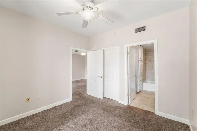 a bathroom with a granite countertop sink toilet tub and shower