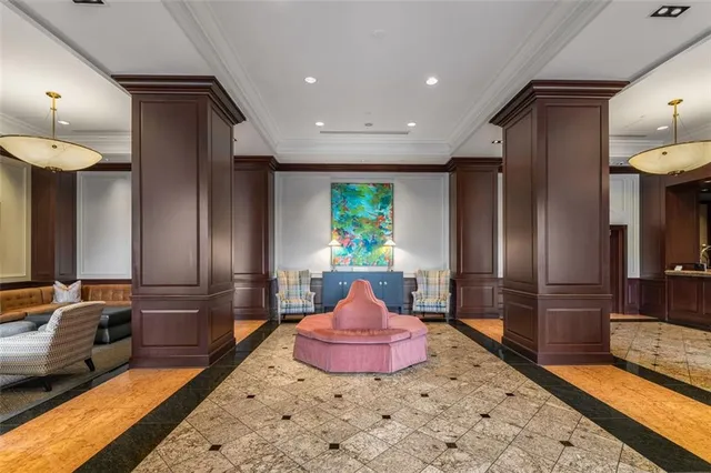 a living room with furniture a chandelier and a rug