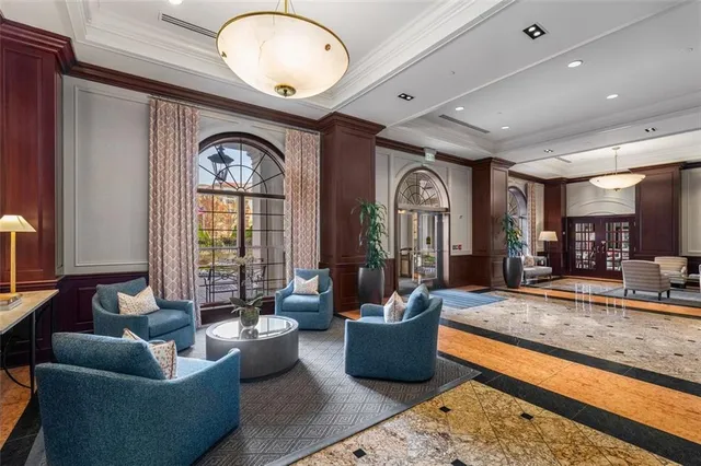 a view of a hallway with wooden floor and furniture