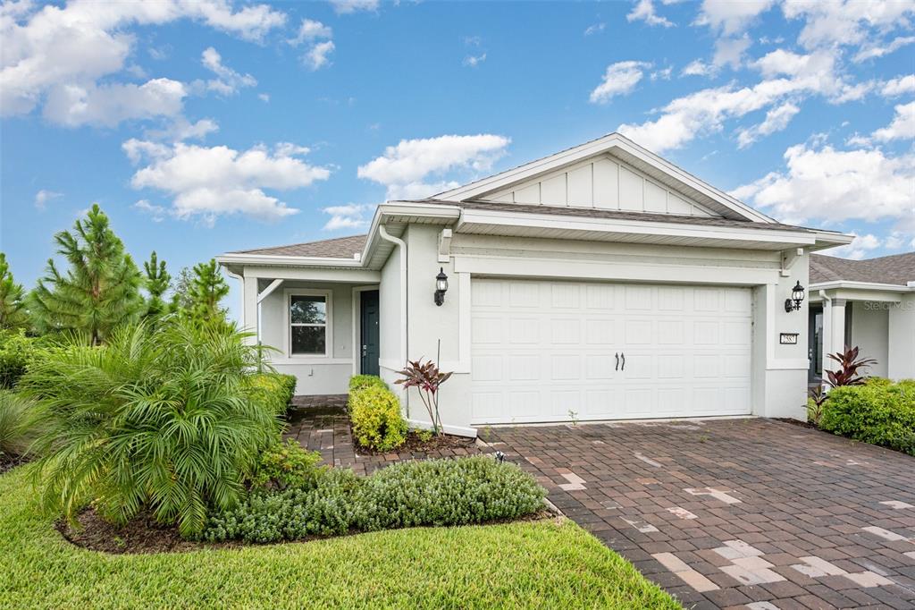 2587 Cliff Way St. Cloud, FL 34771 - Photo 1 of 1 a front view of a house with garden