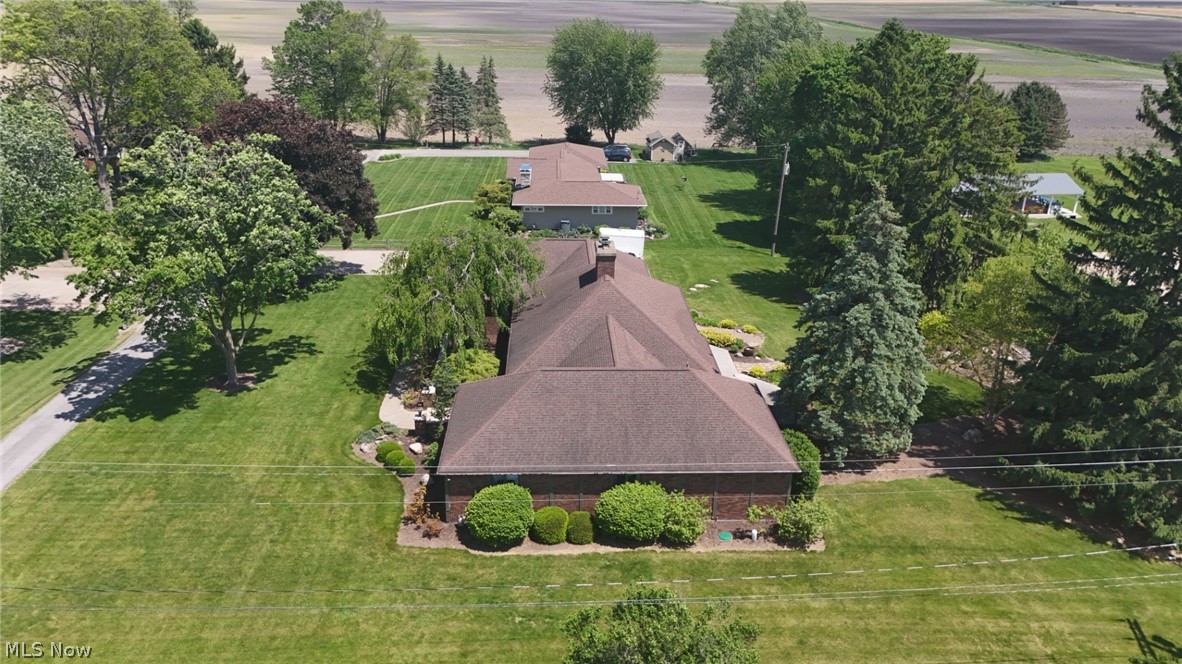 3985 Wiers Road Willard, OH 44890 - Photo 5 of 50 Brown-shingled roofline with extensive manicured lawn