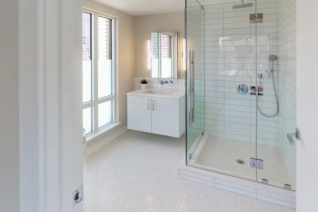 a bathroom with a shower and a sink