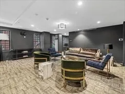 a lobby with furniture and a projector screen