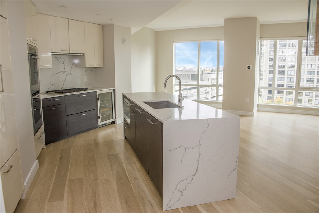 110 Broad Street, Unit 1102 Boston, MA 02110 - Photo 5 of 26 a kitchen with stainless steel appliances granite countertop a sink stove and refrigerator