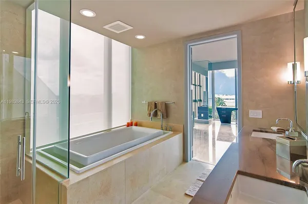 a room with a bed and a view of bathroom