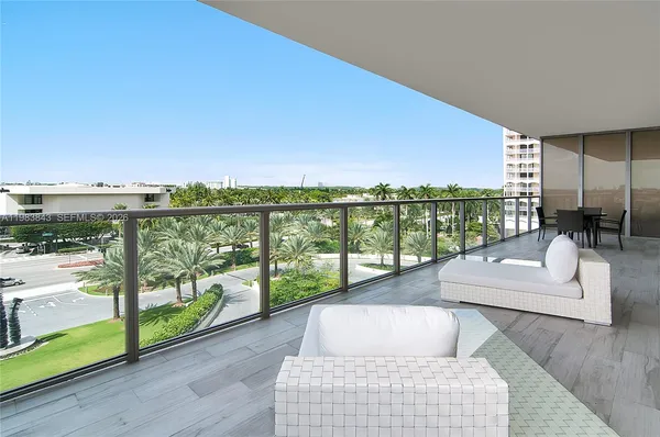 a balcony with furniture and city view