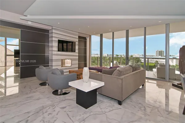 a living room with furniture city view and large windows