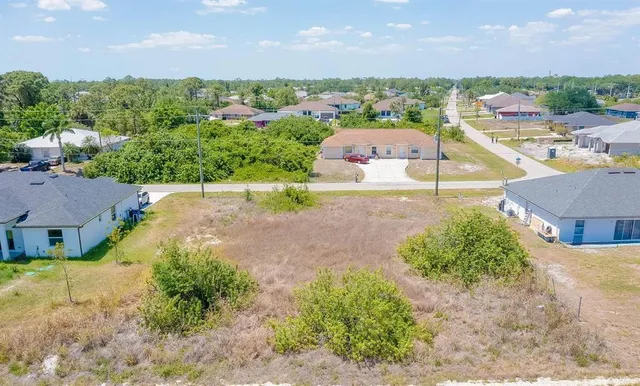 an aerial view of a house with a yard and lake view