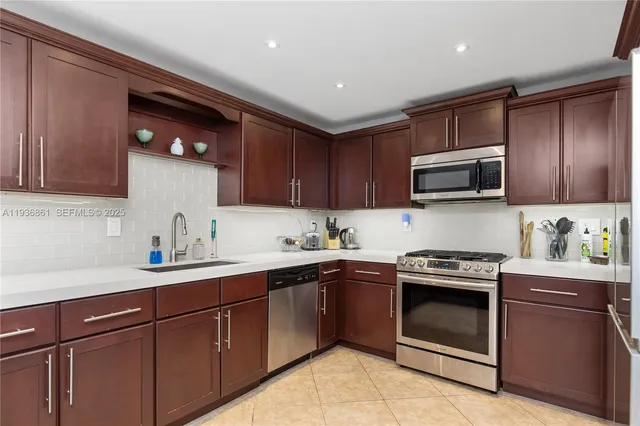 a kitchen with a sink stove top oven and cabinets
