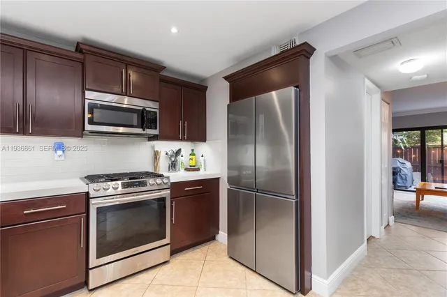 a kitchen with a refrigerator stove and microwave
