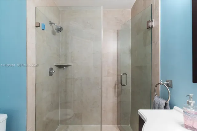 a bedroom with a bed a window and a chandelier