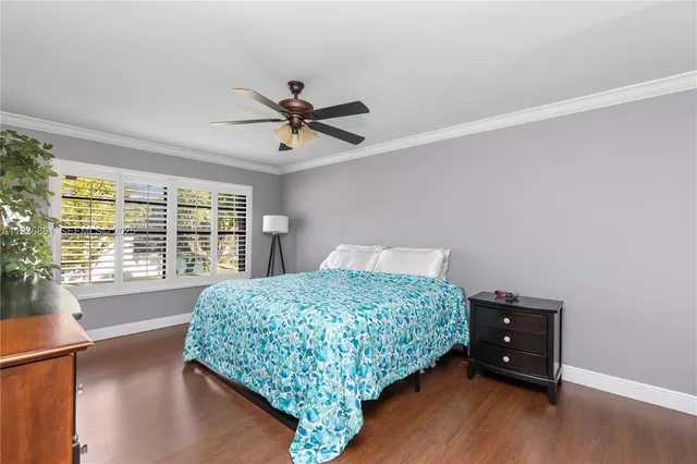 a bedroom with a bed window and a dresser
