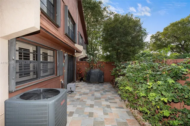a view of pool table and chairs under an umbrella