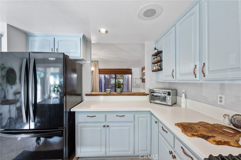 2565 Laramie Road Riverside, CA 92506 - Photo 13 of 46 a kitchen with cabinets and stainless steel appliances