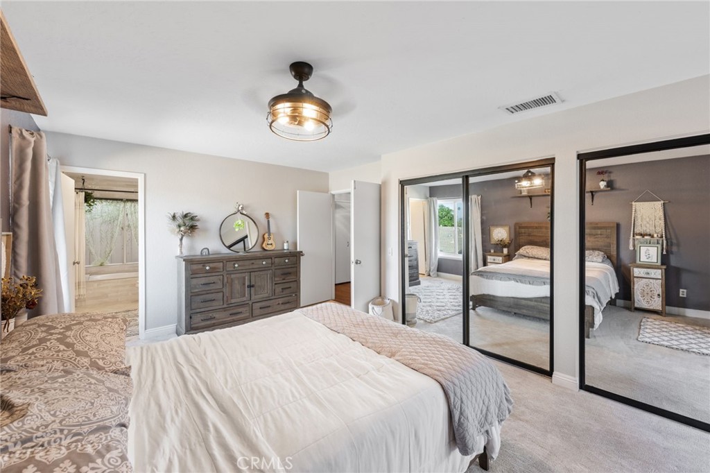 2565 Laramie Road Riverside, CA 92506 - Photo 26 of 46 a bedroom with a bed and a large mirror on a dresser