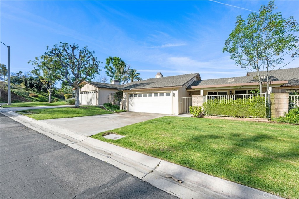 2565 Laramie Road Riverside, CA 92506 - Photo 3 of 46 a front view of a house with a garden and plants