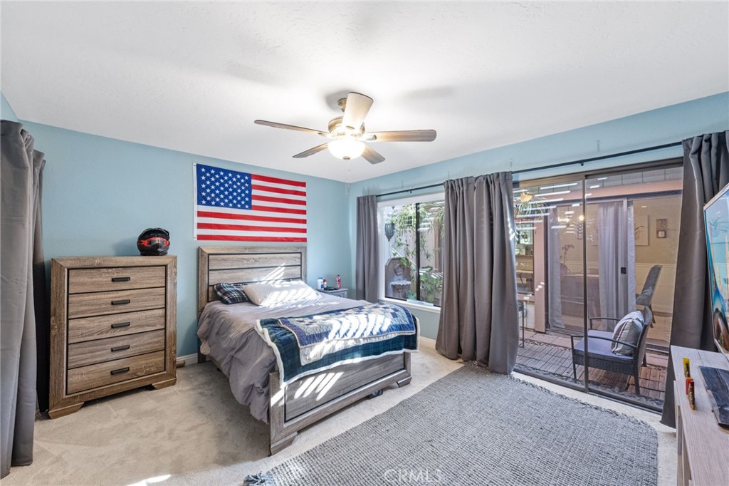 2565 Laramie Road Riverside, CA 92506 - Photo 32 of 46 a bedroom with a bed and a chandelier