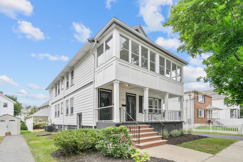 86 Beacon Street, Unit 86 Arlington, MA 02474 - Photo 1 of 19 a front view of a house with a yard