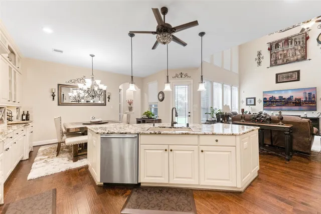 a bedroom with a bed couches and a flat tv screen