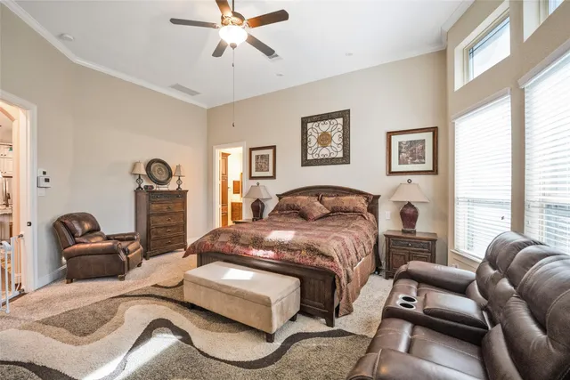 a living room with furniture a floor to ceiling window and a flat screen tv