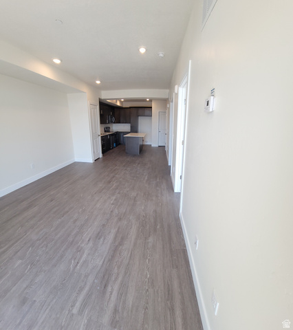 2101 North Main Street, Unit 309 Sunset, UT 84015 - Photo 5 of 17 Unfurnished living room featuring dark wood-type flooring and recessed lighting