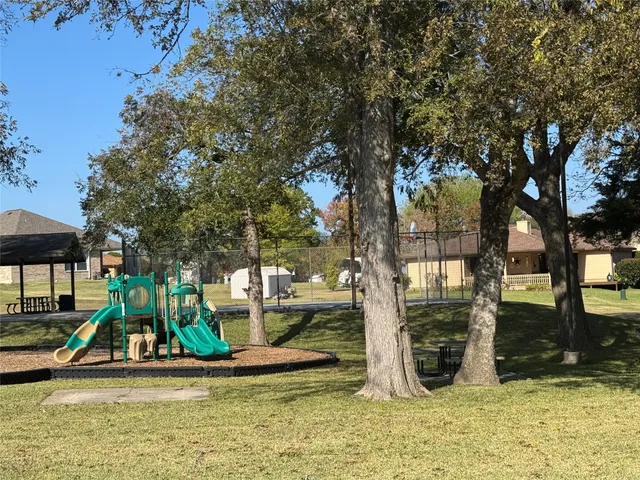 a view of outdoor space with playground and green space