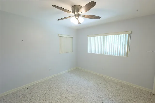 a view of a yard in front of a house with a large tree