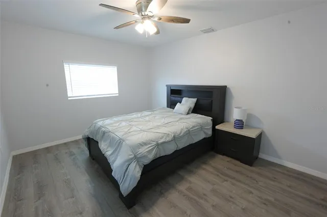 a bathroom with a toilet a sink a mirror a vanity and window