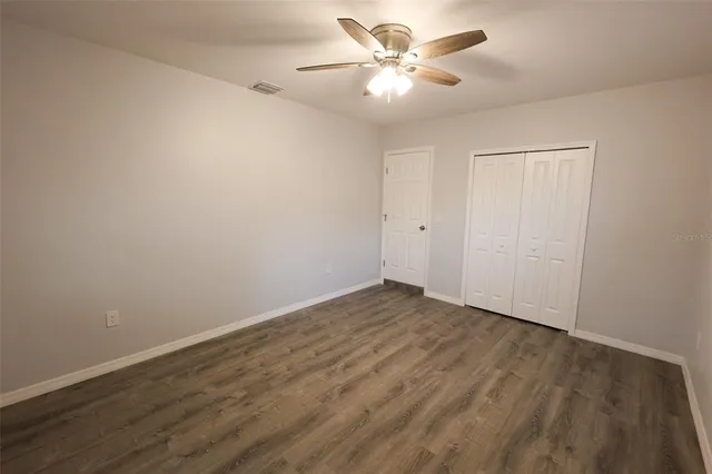 a bathroom with a toilet a sink a mirror a vanity and window