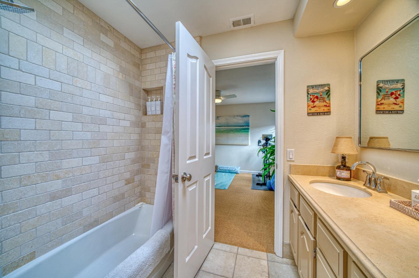 388 Greenbrier Road Half Moon Bay, CA 94019 - Photo 31 of 46 a bathroom with a granite countertop sink a mirror a bathtub and shower
