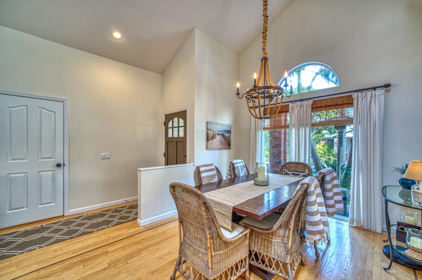 388 Greenbrier Road Half Moon Bay, CA 94019 - Photo 10 of 46 a view of a dining room with furniture a chandelier and wooden floor