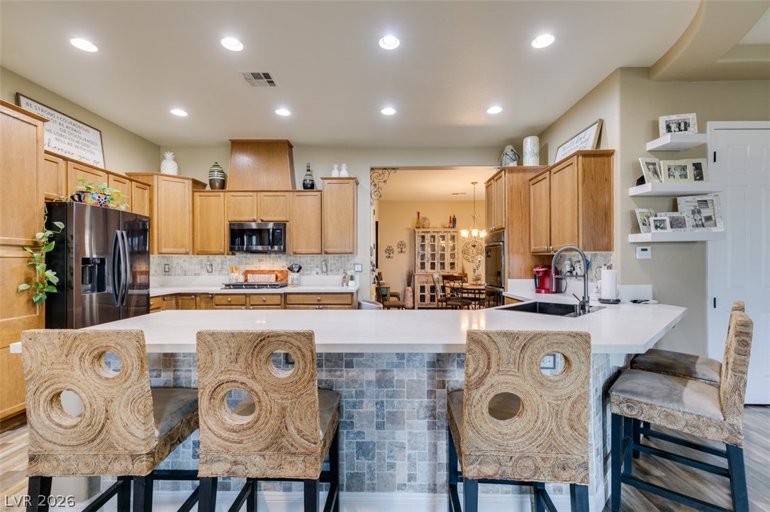 7524 Midnight Rambler Street Las Vegas, NV 89149 - Photo 19 of 51 A grand central island provides ample counter space in this naturally illuminated kitchen.