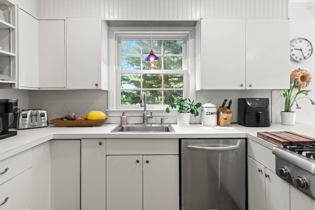 44 Crestwood Road Marblehead, MA 01945 - Photo 18 of 42 a kitchen with stainless steel appliances granite countertop a sink a stove and a wooden cabinets