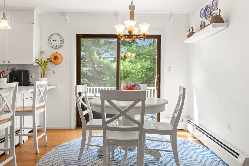 44 Crestwood Road Marblehead, MA 01945 - Photo 19 of 42 a view of a dining room with furniture a chandelier and wooden floor