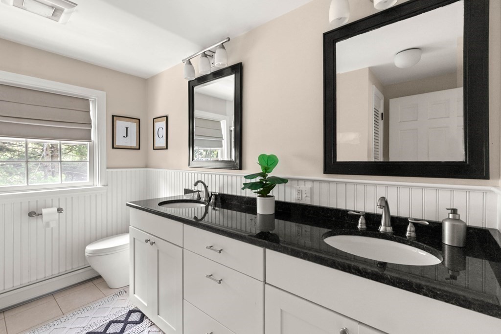 44 Crestwood Road Marblehead, MA 01945 - Photo 26 of 42 a bathroom with double vanity sinks a toilet a mirror and a window