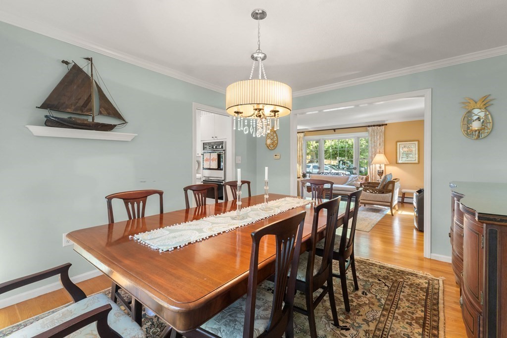 44 Crestwood Road Marblehead, MA 01945 - Photo 8 of 42 a dining room with furniture a rug and a chandelier