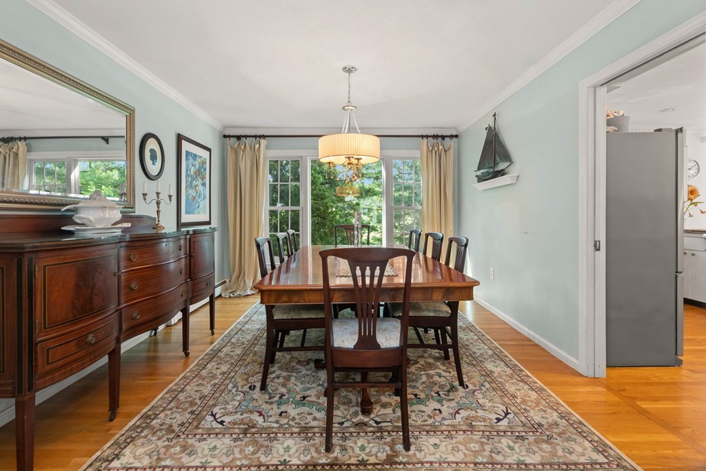 44 Crestwood Road Marblehead, MA 01945 - Photo 9 of 42 a dining room with furniture a chandelier and wooden floor
