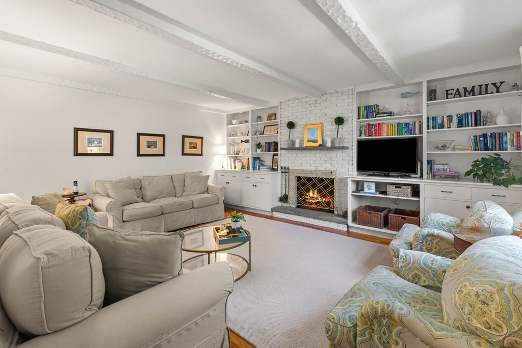 44 Crestwood Road Marblehead, MA 01945 - Photo 10 of 42 a living room with furniture a flat screen tv and a fireplace